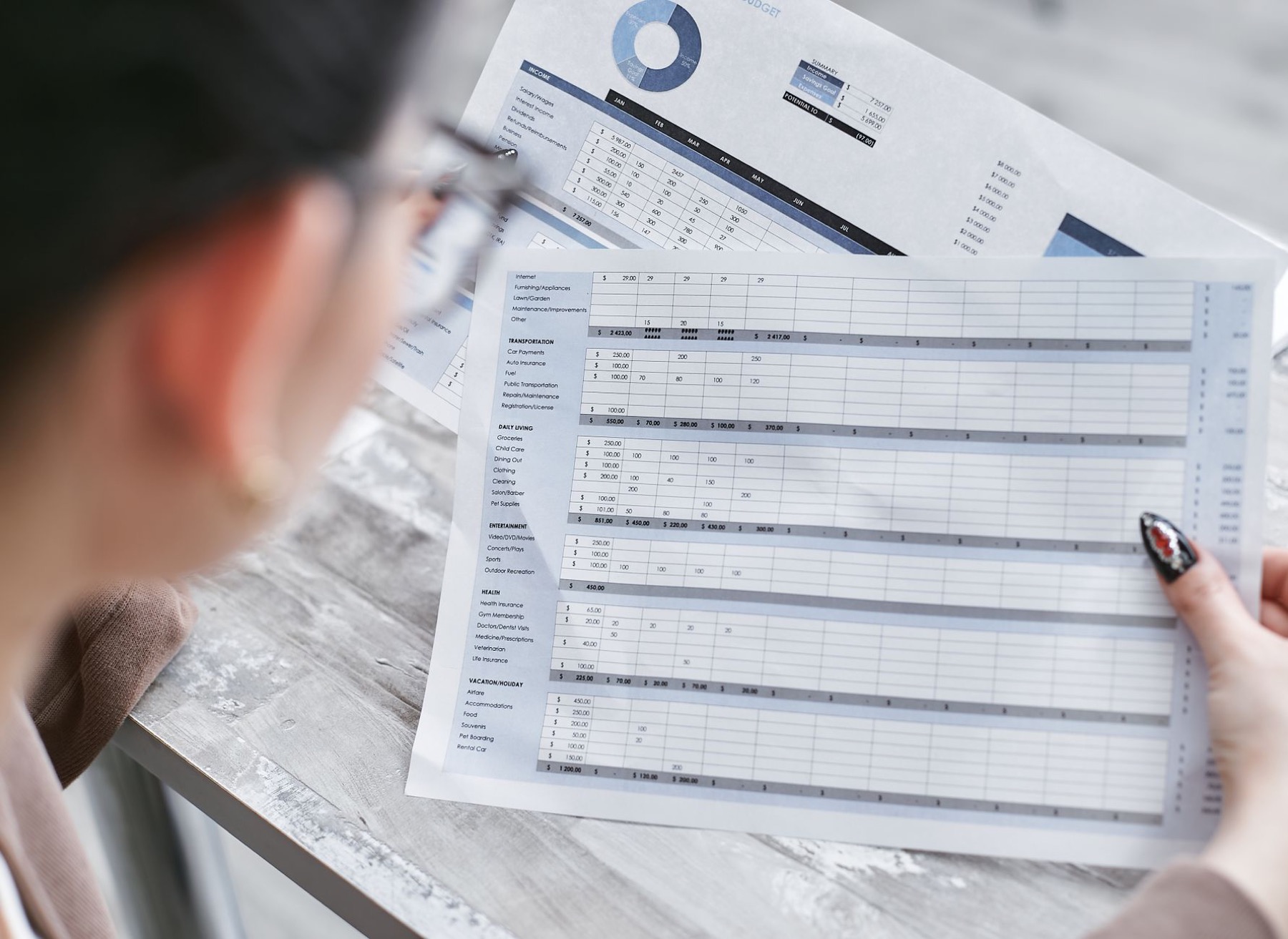 A business operator reviewing documents and charts during an audit.